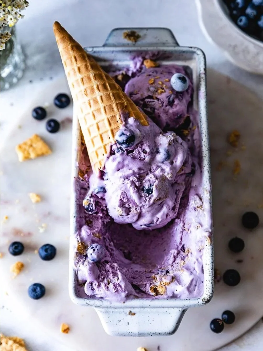 Would you believe me if I told you this ice cream tastes just like your favorite cheesecake in a cone?! This eggless ice cream is loaded with fresh blueberries for a bright burst of flavor in every bite, plus plenty of graham cracker pieces for that 