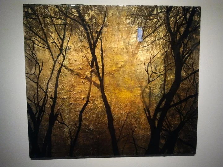 An abstract painting of a forest scene with silhouetted trees and a textured background in autumn colors.