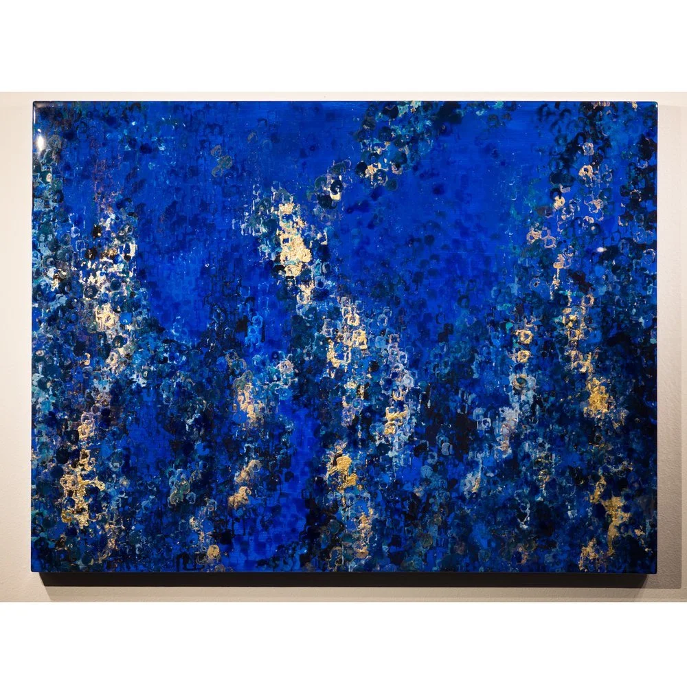 Abstract painting with shades of blue and accents of gold and silver, resembling a starry or cosmic scene.