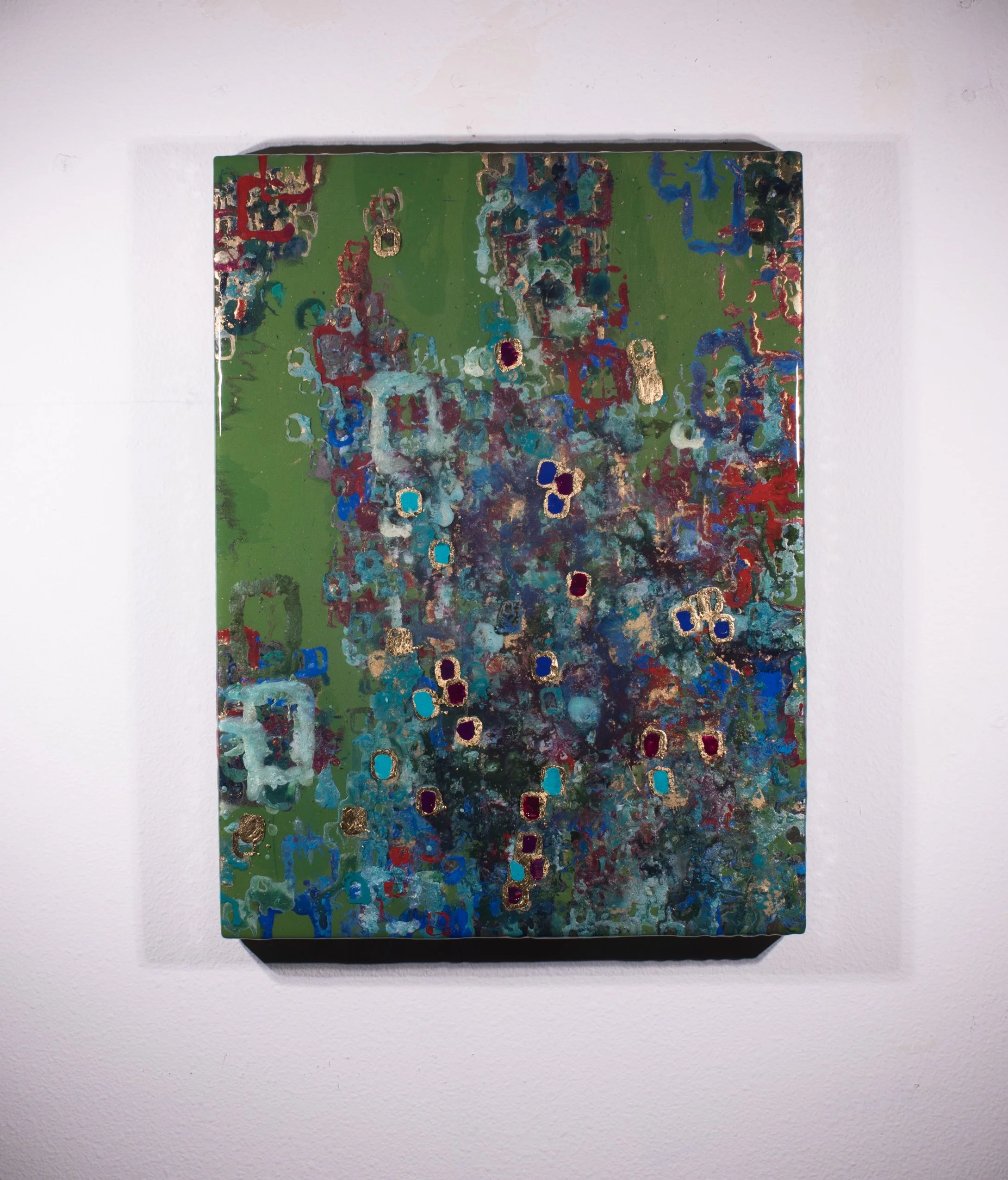 Abstract painting with green background and multicolored squiggly shapes and gold accents.