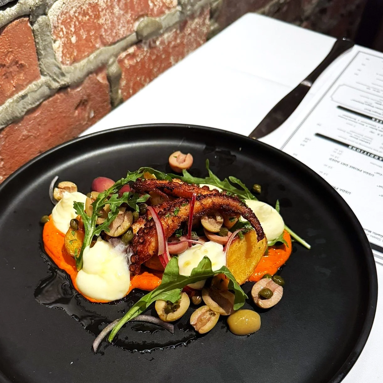 Braised Octopus: Sweet Pepper Romesco, Crispy Potato, Whipped Manchego, Olive, Caper