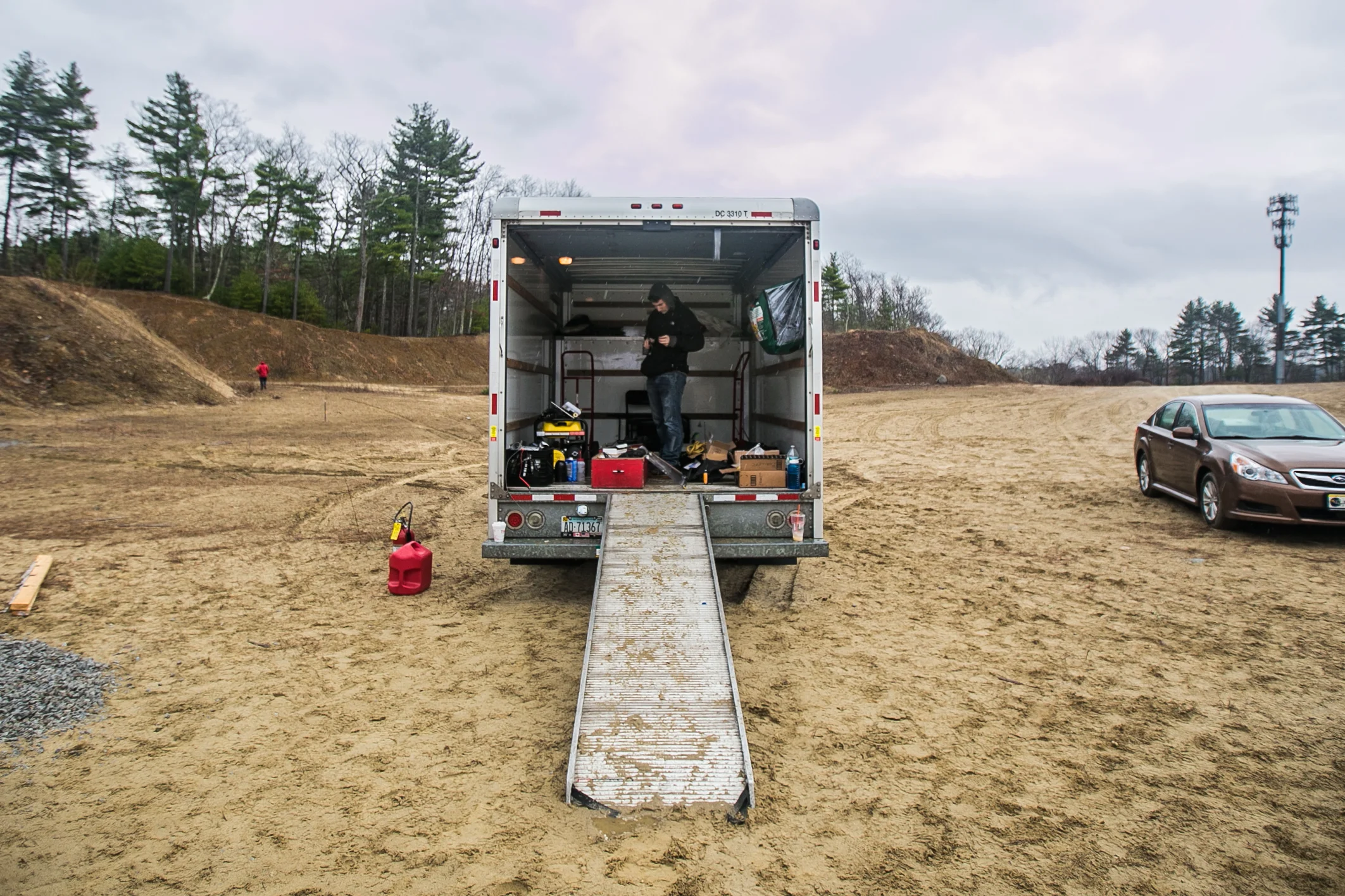 April 2, 2016 – Doug Lescarbeau, of the Boston University Rocket Propulsion Group, grabs supplies from the U-Haul truck during a test run of the liquid bi-propellant Lotus engine. The rocket development team established a safe testing site in the town of Sudbury, Mass. about 35 minuets outside of Boston. Over the past four years they have conducted over 20 engine tests at this location, and plan to reach space by the summer of 2017. Two of the Lotus engines will eventually be installed on the Starscraper, a 30 foot 1200 pound rocket, and launched from the Black Rock Desert in the summer of 2017. The Boston University team is in a tight race with the University of Southern California to be the first student designed and constructed rocket to reach space – or about 62 miles above the earth’s surface. © Mike Schwarz