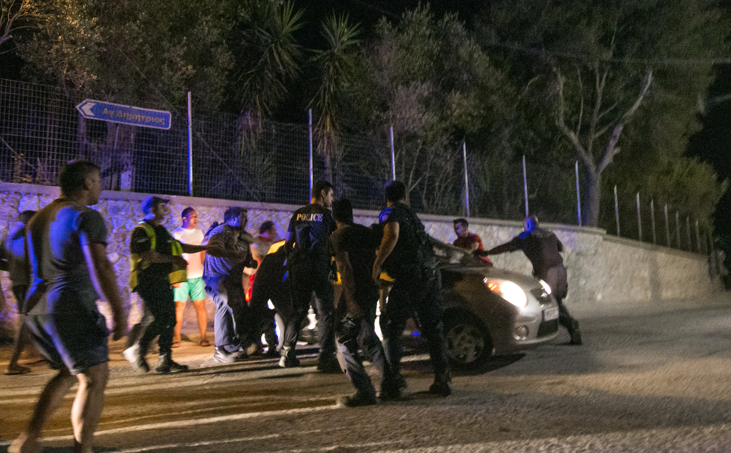  Greek Police pull Moria residents off of a volunteers car. The residents punched and kicked the hood, windows, and doors. After the car attempted to drive away, residents blocked the path, and attempted to pull one of the volunteers out of the passe
