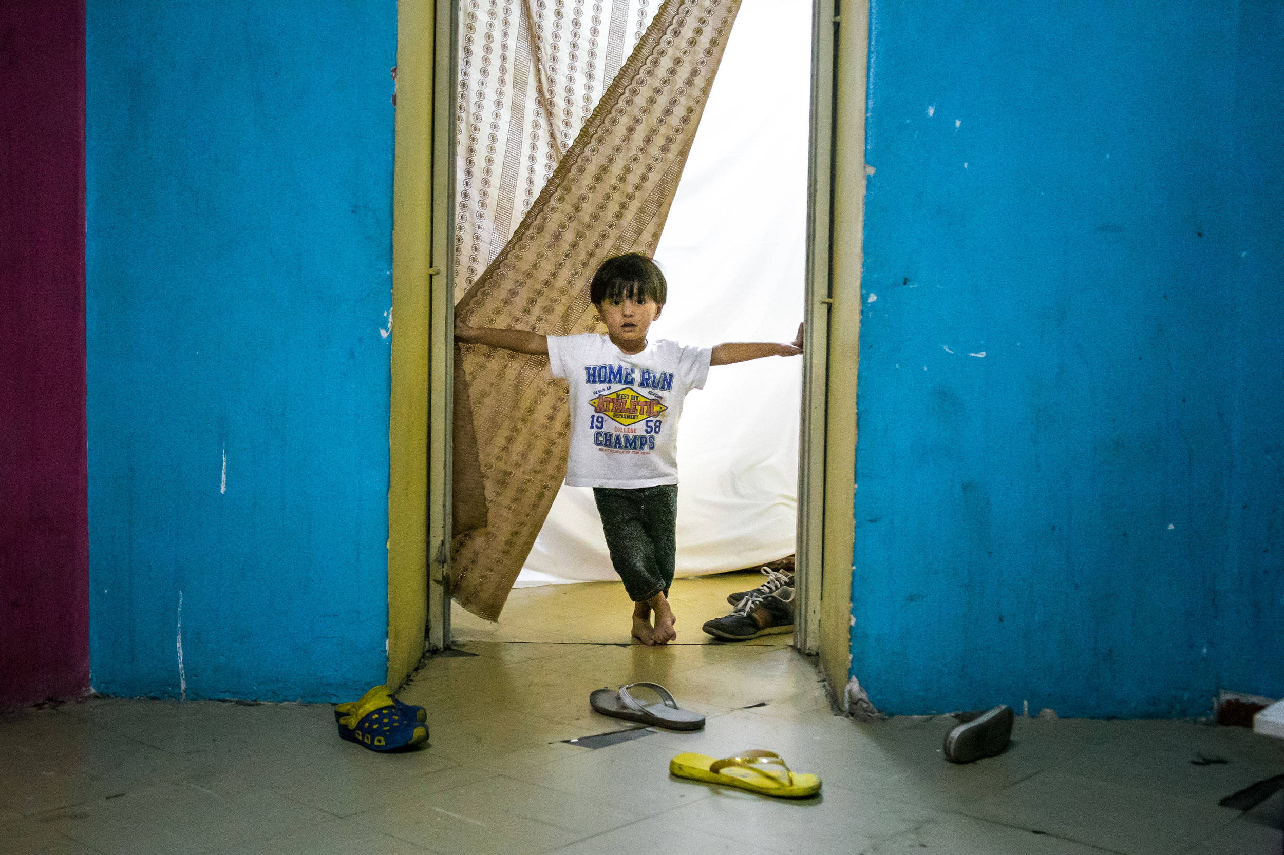  Alush Alowi, 4, of Syria, stands in the doorway of a condemned school in Athens, Greece where he and his family have been squatting for the past 2 months. The school houses over 400 refugees that are trapped in Greece after the majority of European 