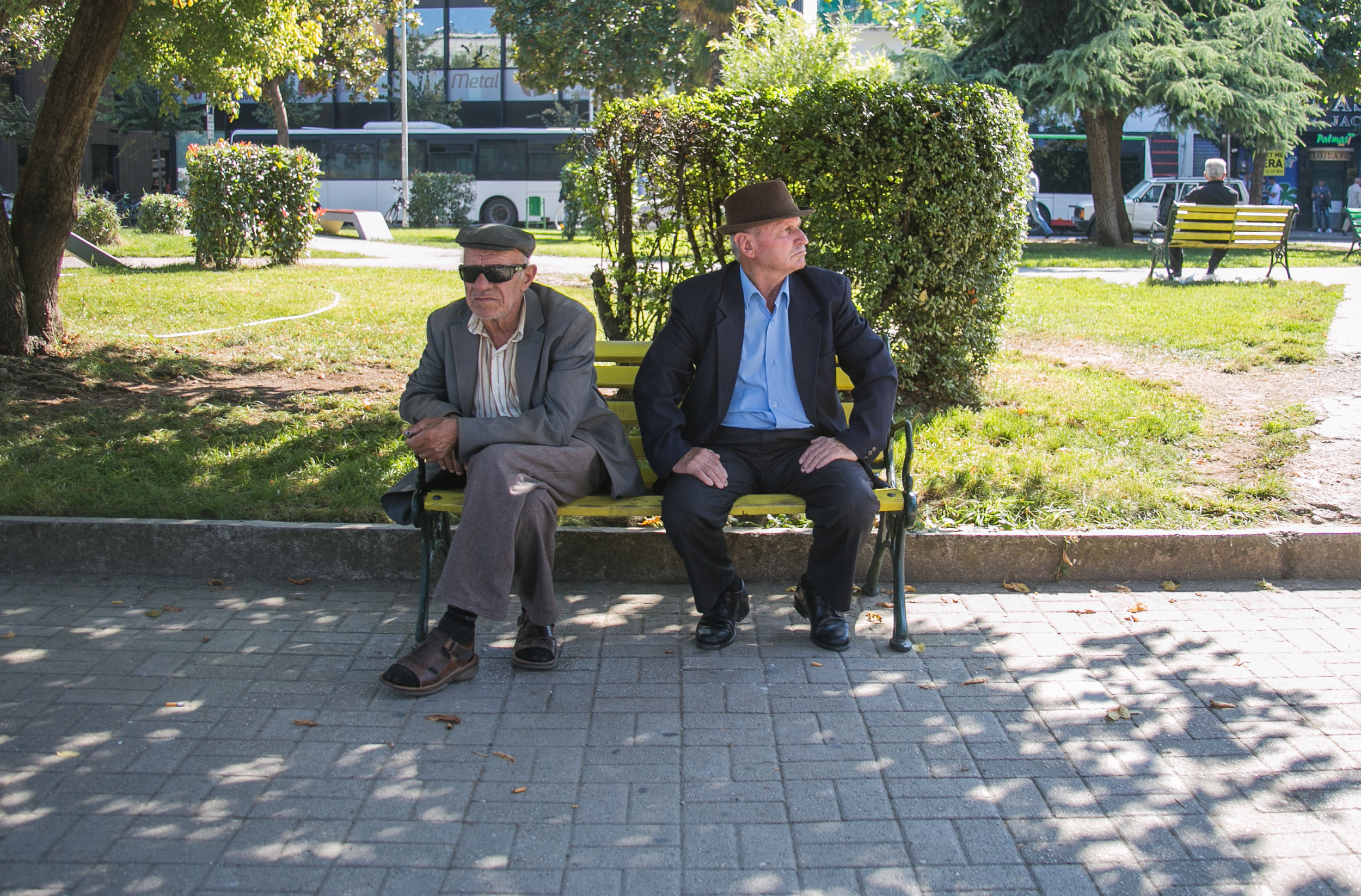  Two Albanian men sitting on a bench in Tirana. 