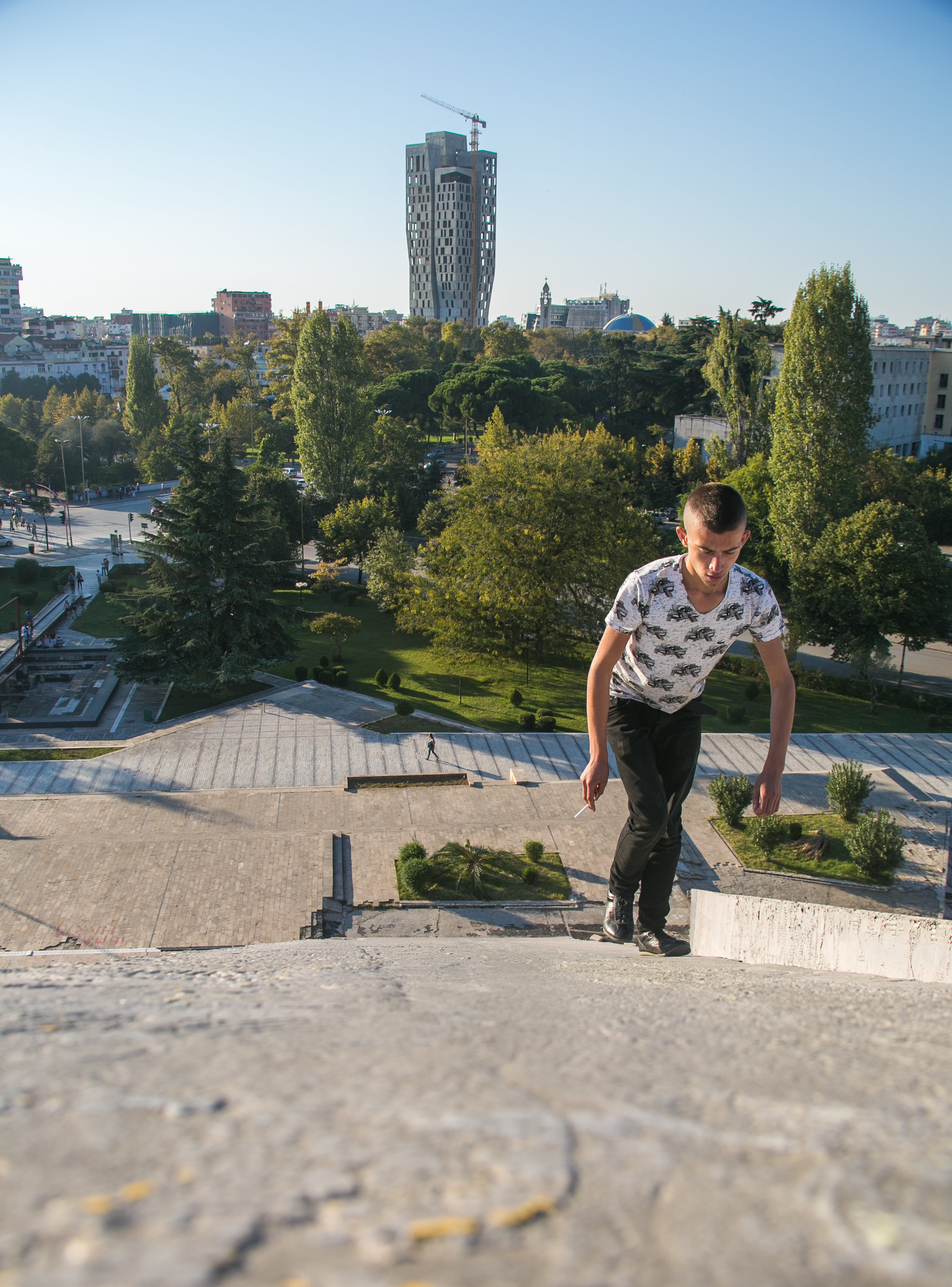 An Albanian boy climbs the Pyramid of Tirana. The city does not discourage climbers from hanging out on or atop the abandoned monument. 