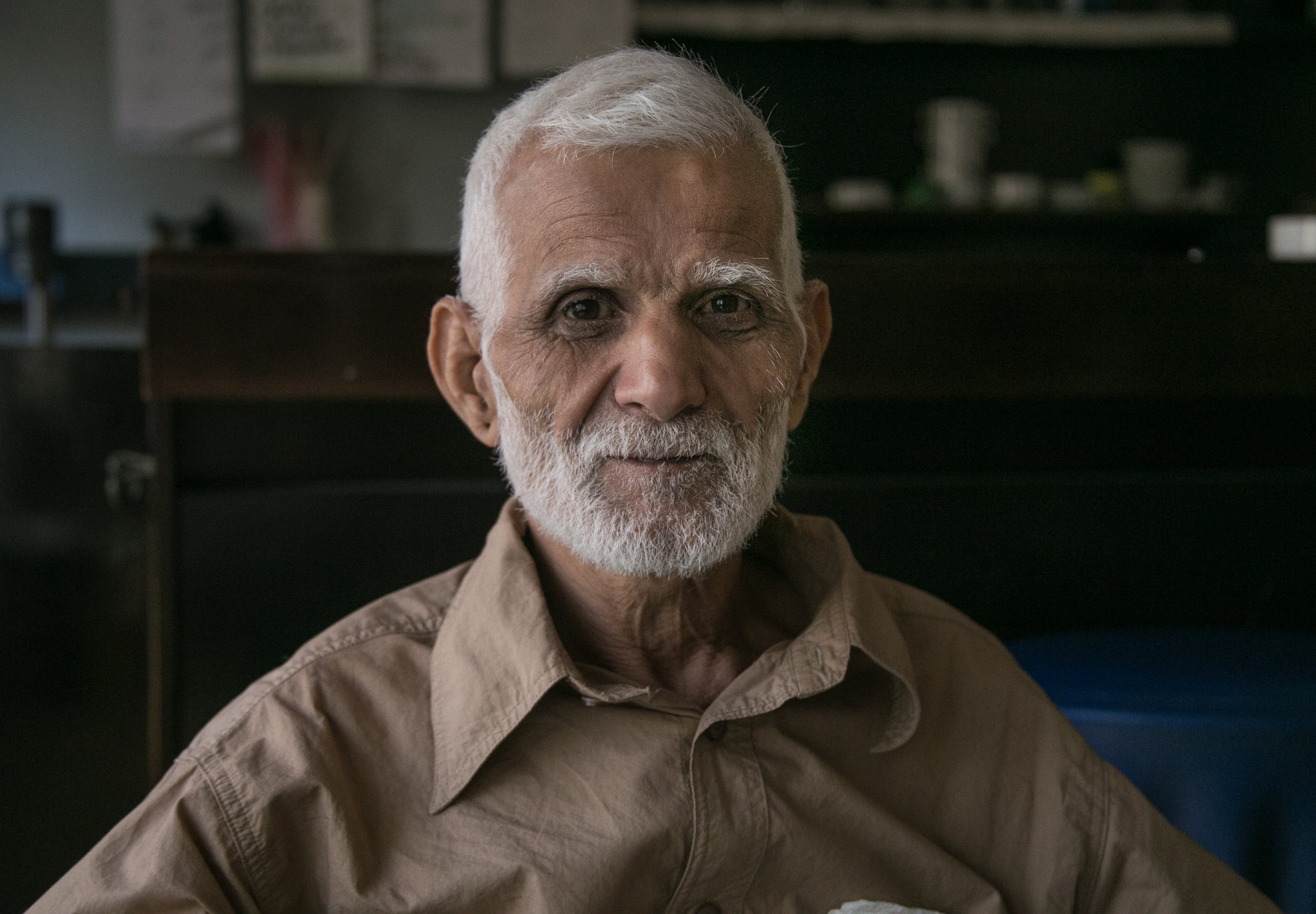  09/26/16 - Hamit M., an Iranian refugee living in City Plaza for four months, sits in the bar area before dinner. Hamit often assists in the kitchen and cafeteria area. On this day he arranged all the chairs and tables in preparation for dinner. 