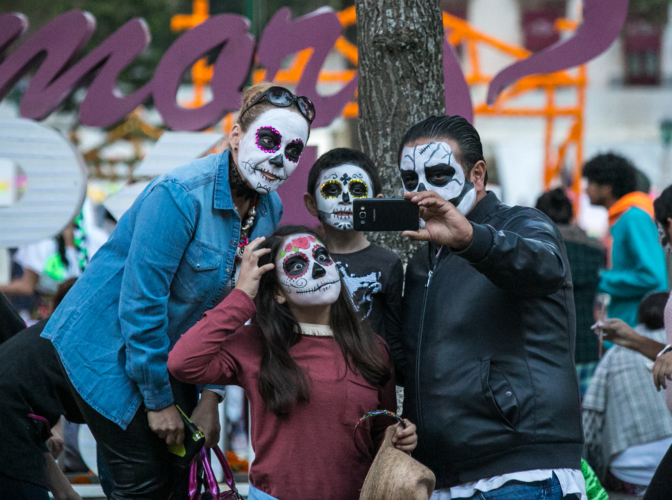  10/31/17 - 6:00pm - A family of tourists from Canada take a selfie in front of the marigold-clad town sign. 