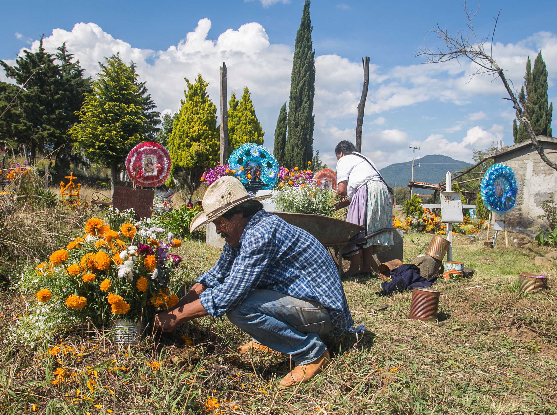  11/1/17 - Jose Luis Doroteo and his mother tend to his grandmother's gravesite. 