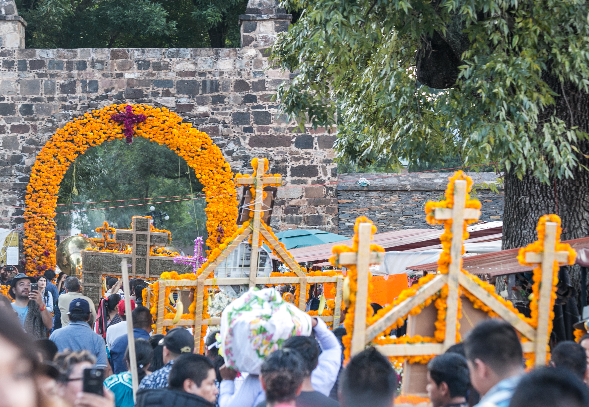  11/1/17 - Families march with their altars to the church service being held in the town park. 