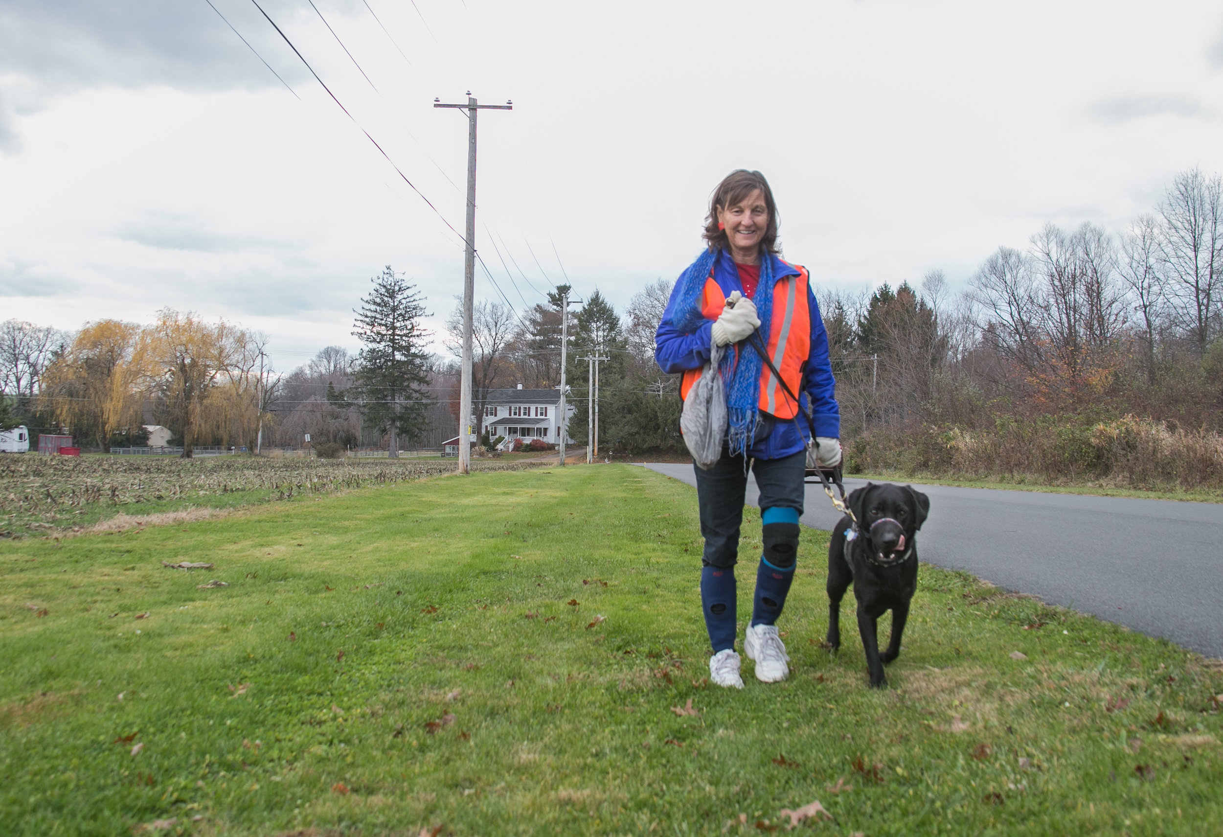  A volunteer walks one of the trainees on the campus of the Canine Partners for Life Headquarters in Cochranville, PA. 