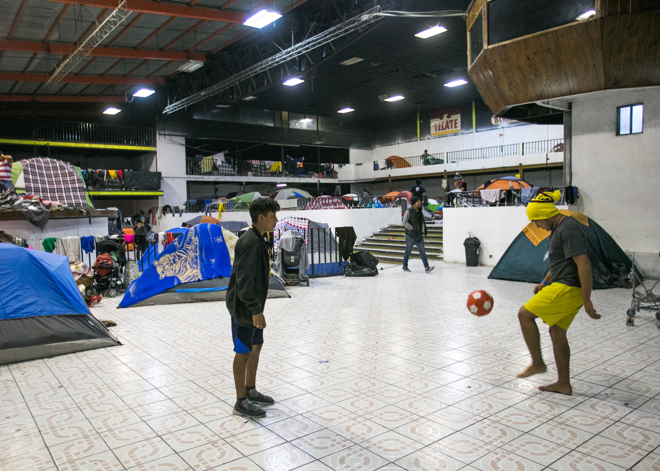  Children play soccer in the main section of the Barretal refugee camp located just outside of Tijuana, Mexico. 