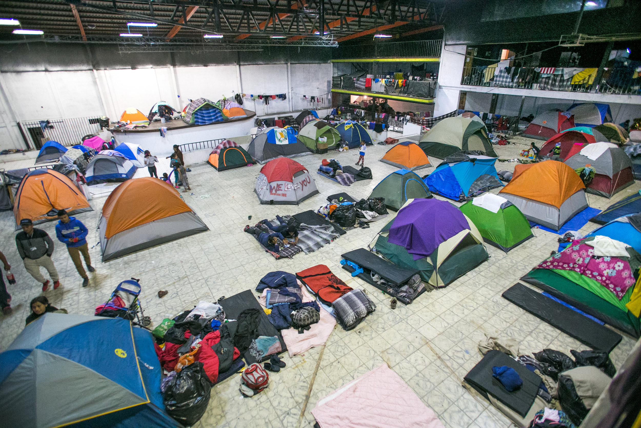  Tents pack the inside of a dimly lit abandoned warehouse space re-purposed as the Barretal migrant compound just outside Tijuana, Mexico. The Mexican government relocated over 2,000 refugees to this facility after the first camp in Central Tijuana w