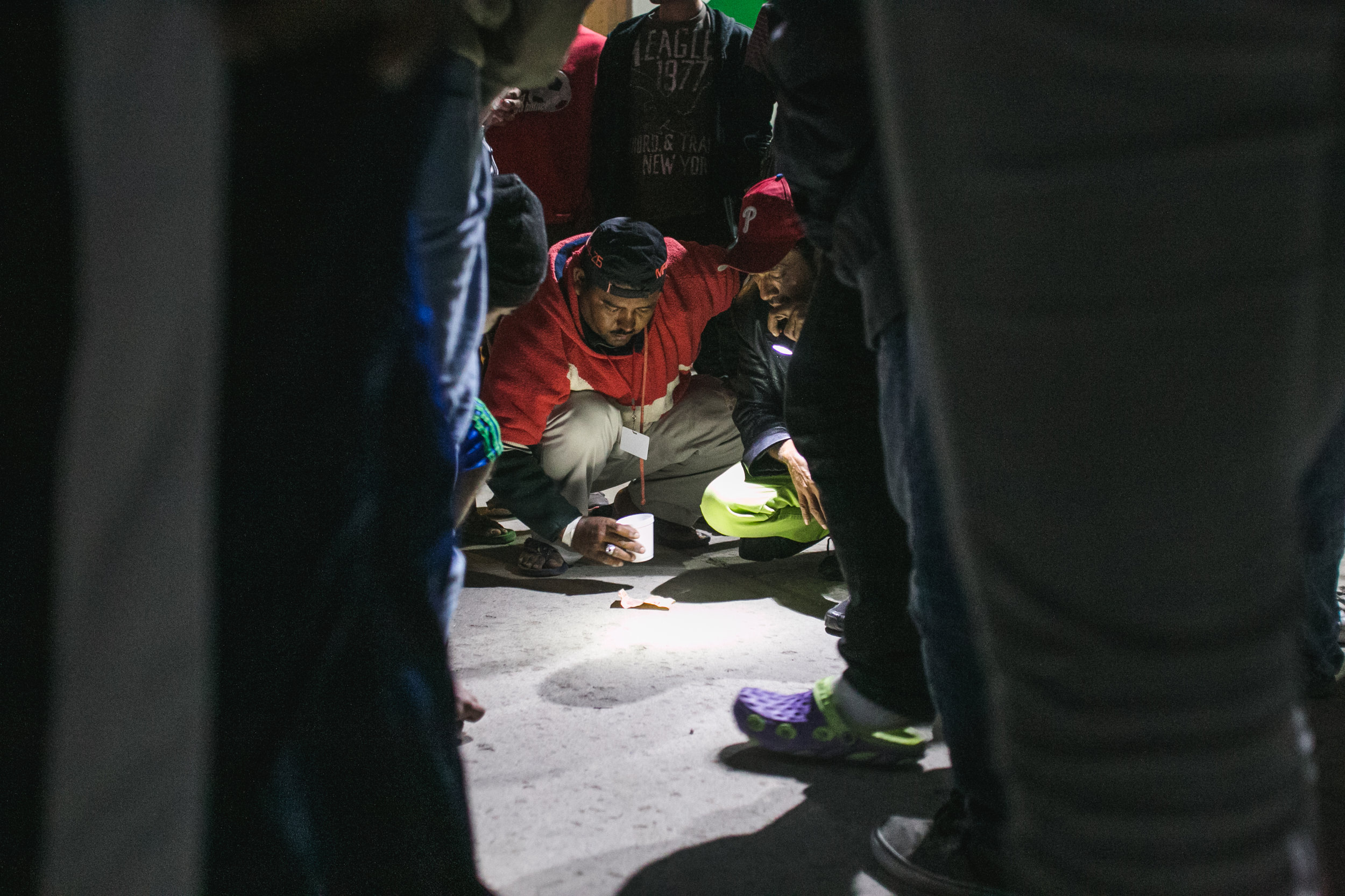  Men gamble with dice on the ground of the Barretal refugee compound located just outside Tijuana, Mexico. Gambling, soccer, and card games are among the most popular activities to pass the time. 