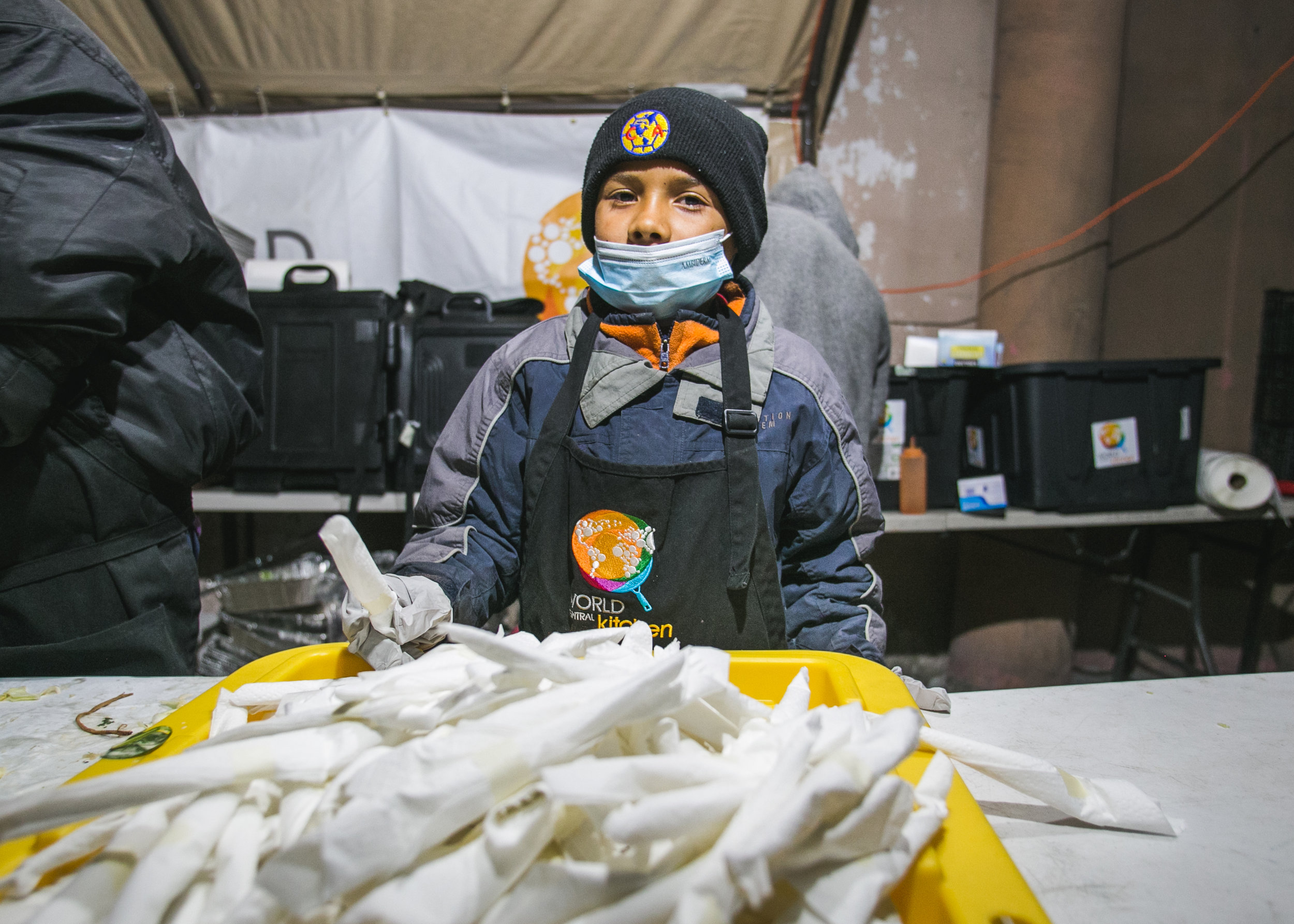  Johnathan Torres, 10, of Honduras, serves dinner to over 1,500 refugees. Each day, 5-6 children from the camp would assist World Central Kitchen with serving lunch. The goal of the program surrounds creating a sustainable refugee-operated kitchen in