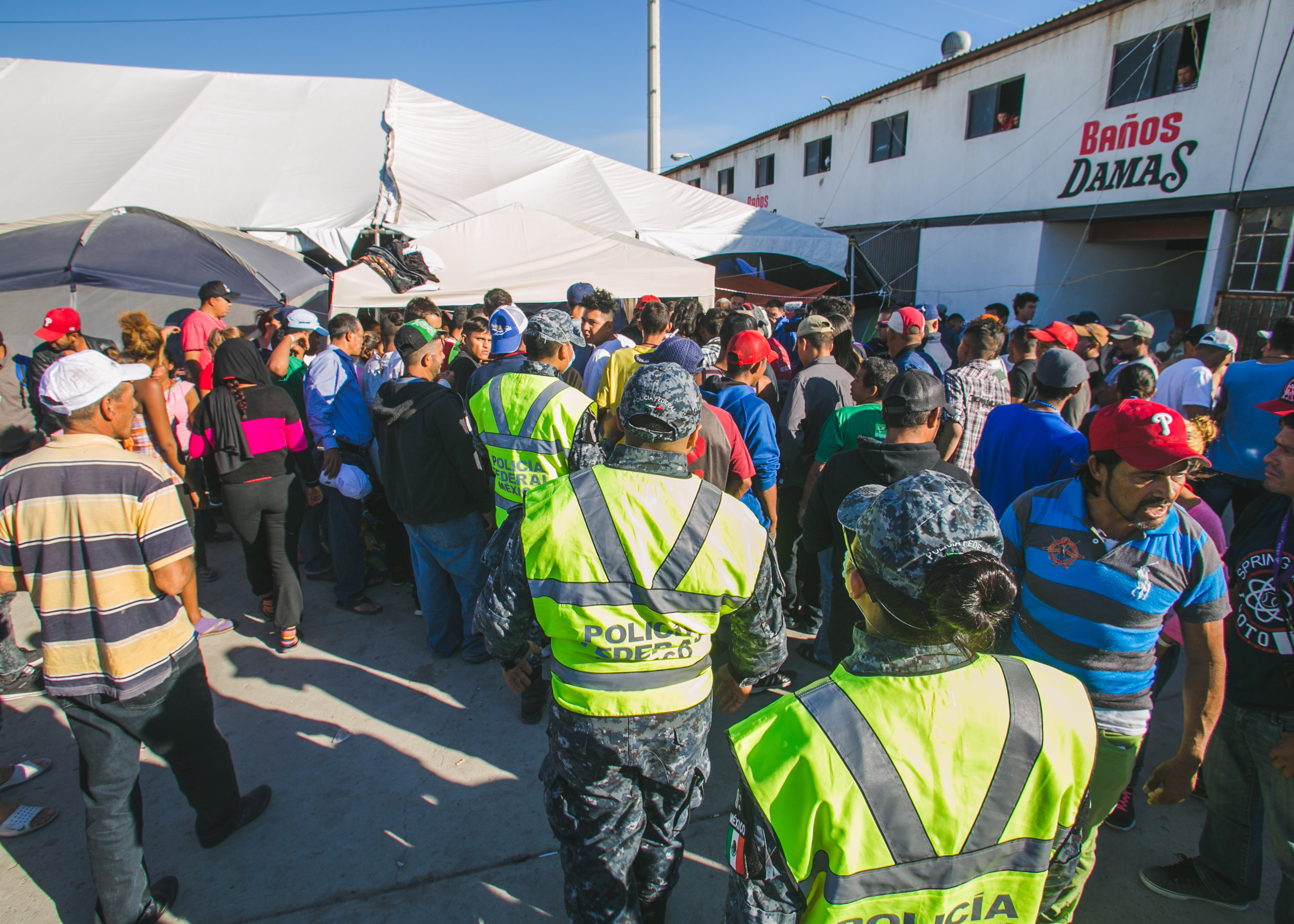  Federal Police approach a skirmish between local police and a refugee being accused of selling cigarets to minors. The accusations caused a uproar in the camp. Many began chanting of unfair treatment - and the need to remove a police presence from t