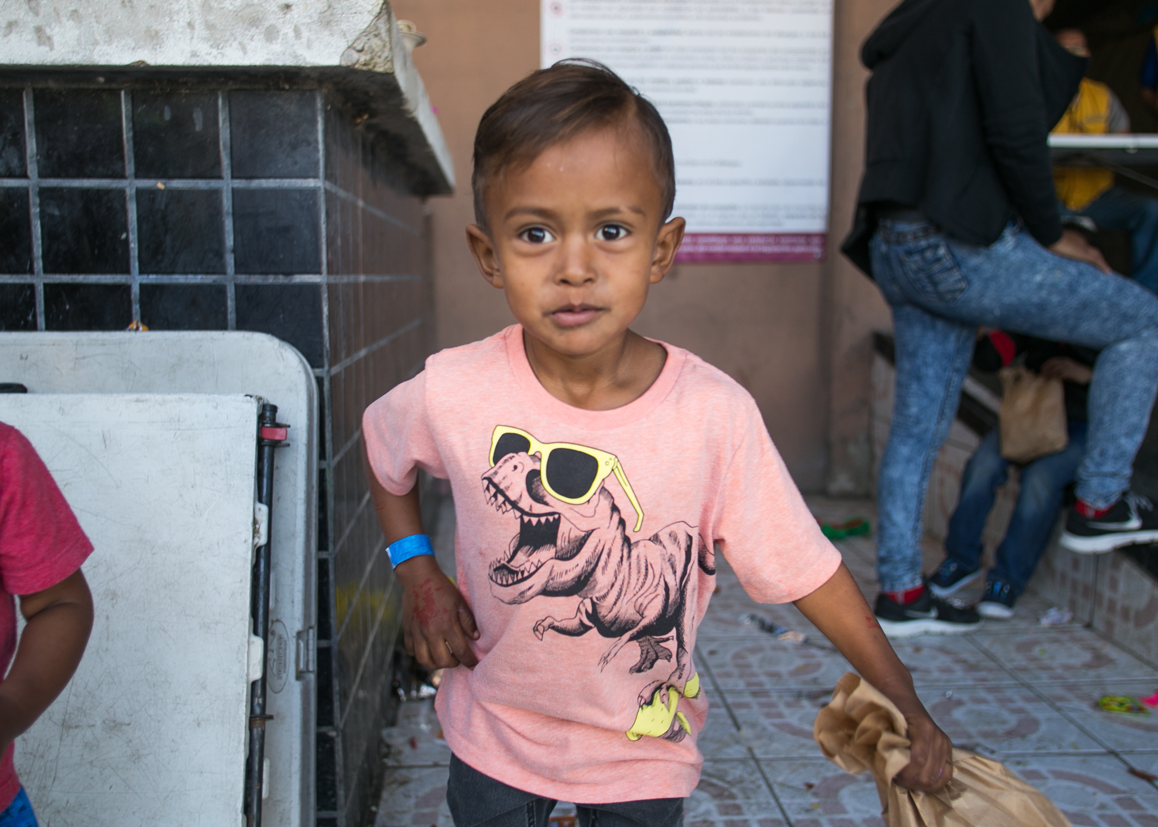  A refugee child holds a bag of candy he recently procured from a donated piñata. Despite a great deal of healthy home-cooked food being served at the camp - the majority of the campers (including adults) are more enthusiastic about candy, chips, and