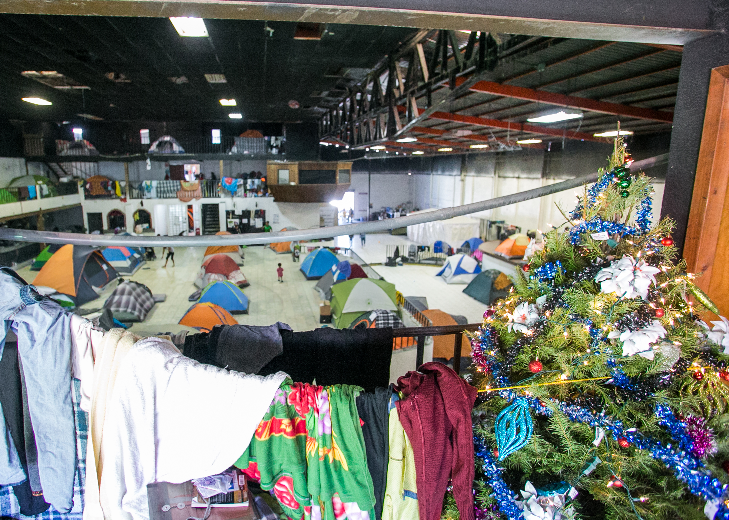  Laundry dries next to a Christmas tree that was recently donated to the Barretal refugee camp in Tijuana, Mexico. Many families have been waiting for over two months - and will spend Christmas in the compound. 