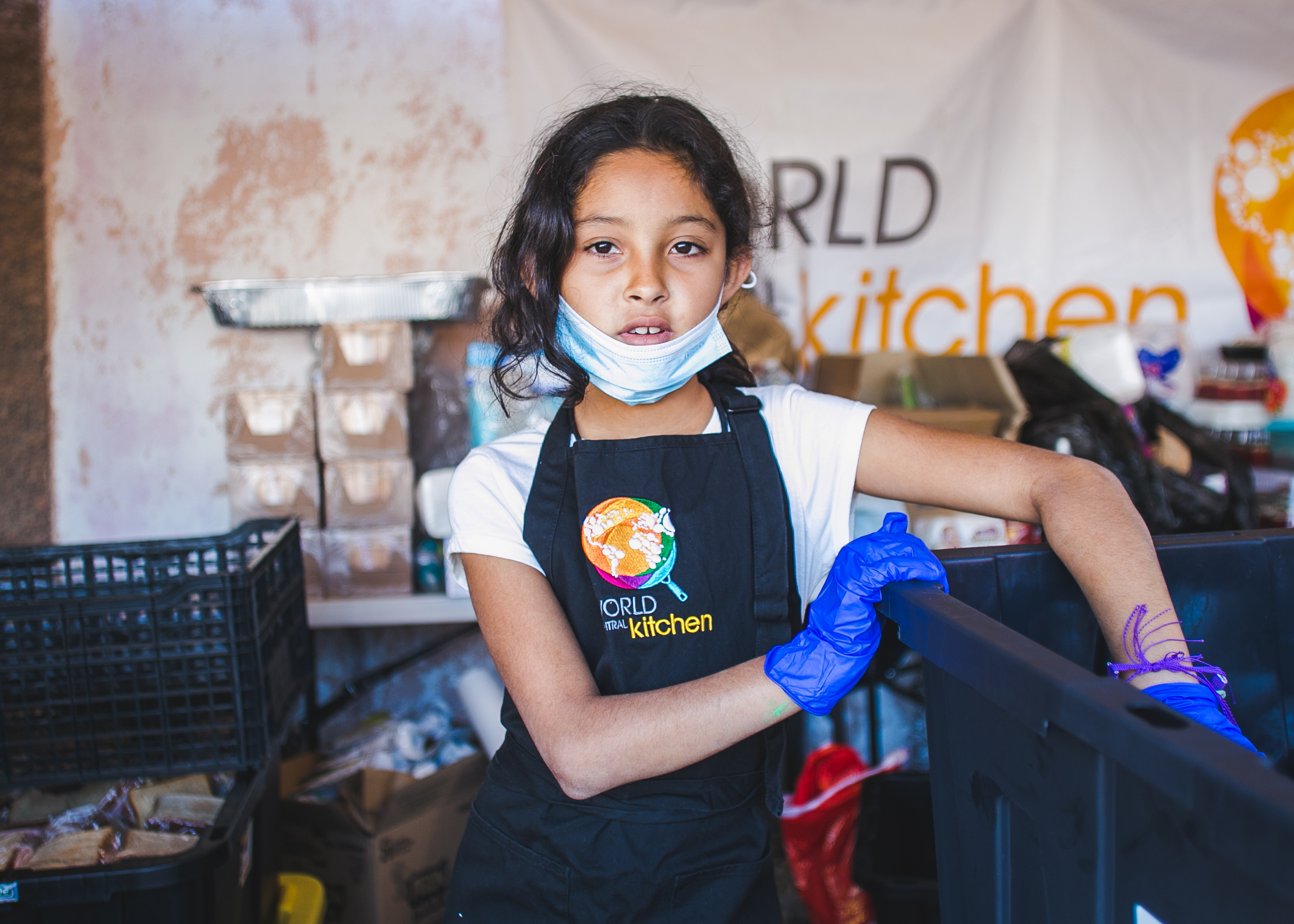  A refugee and kitchen volunteer serves lunch to over 1,500 at the Barretal camp in Tijuana, Mexico. Each day, 5-6 children from the camp assist World Central Kitchen with serving lunch and dinner. The goal of the program surrounds creating a sustain