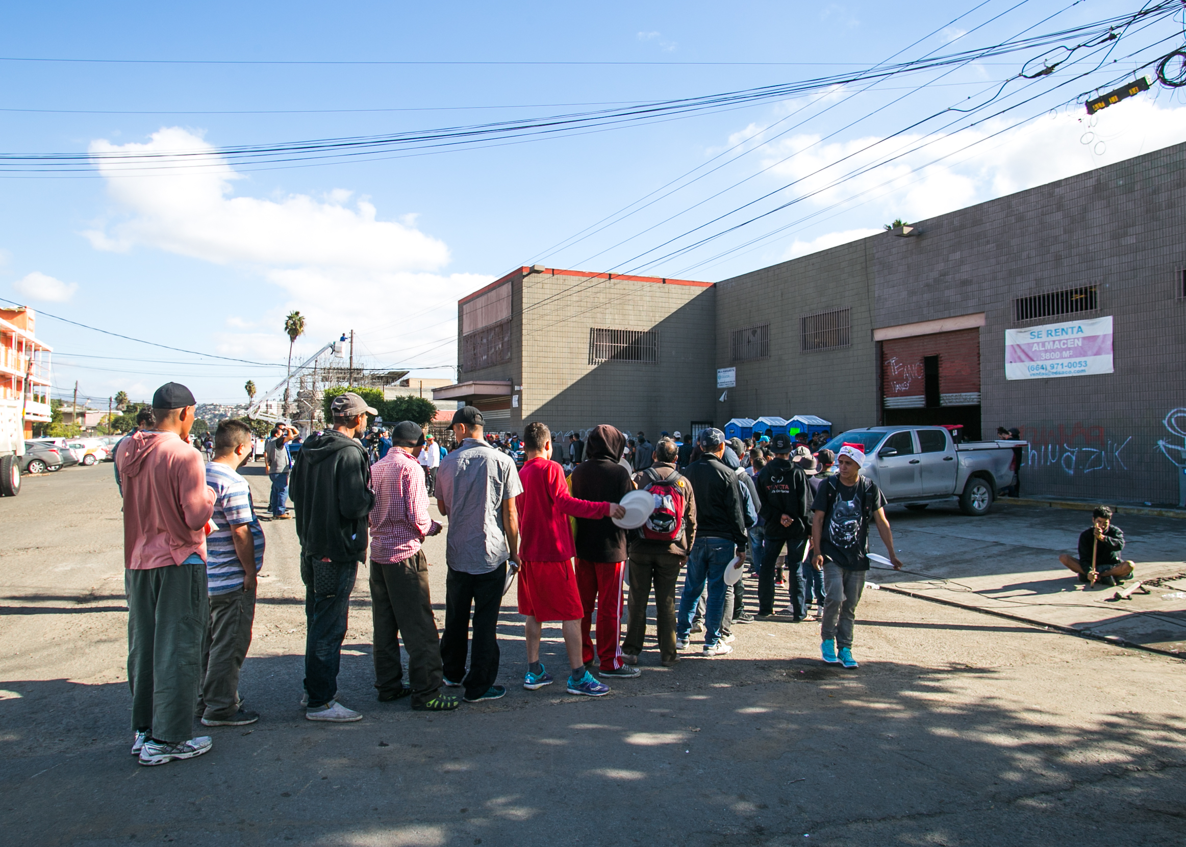  A line of refugees waiting for food snakes into the street outside the El Chinchetta compound in Central Tijuana. Due to complaints from the local community - food, donation, and medical services were suspended in an effort to encourage those seekin