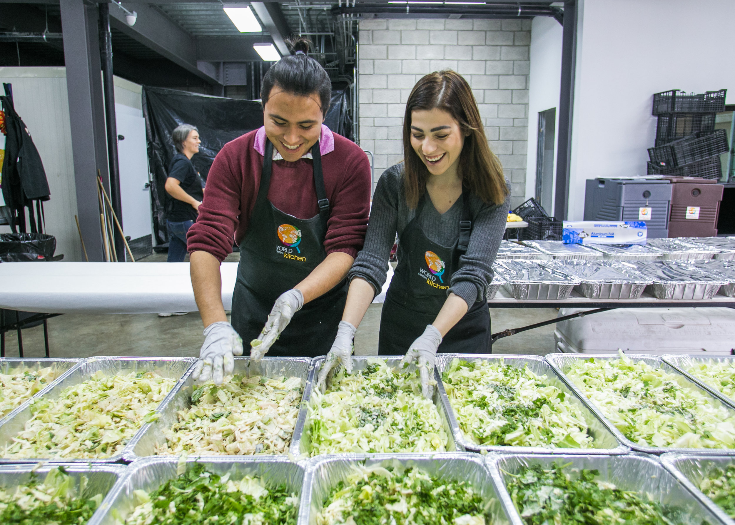  Oscar Montana, a volunteer from a local Tijuana university, prepares dinner at the World Central Kitchen Headquarters.  