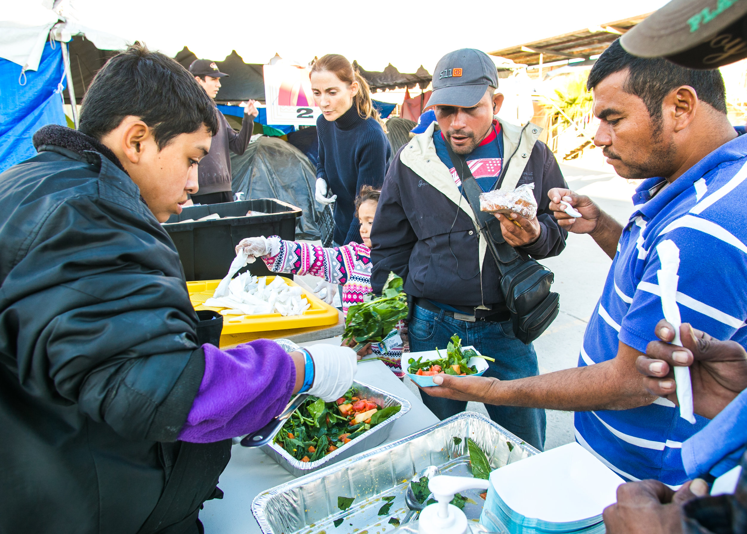  A volunteer serves lunch to over 1,500 refugees at the Barretal refugee compound. Each day, 5-6 children from the camp would assist World Central Kitchen with serving lunch. The goal of the program surrounds creating a sustainable refugee-operated k