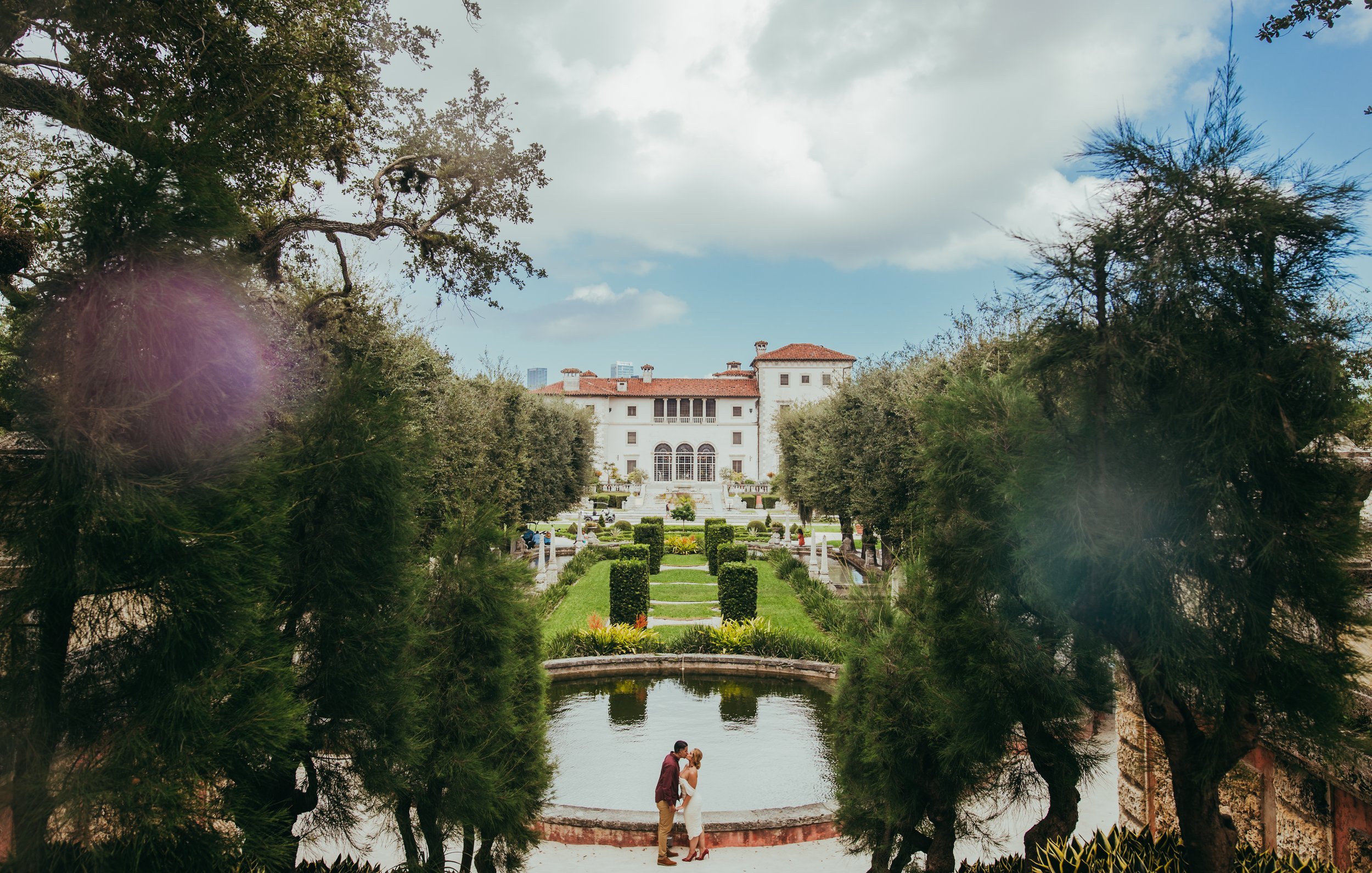  Bride and groom holding hands in kissing in a beautiful estate in Miami 
