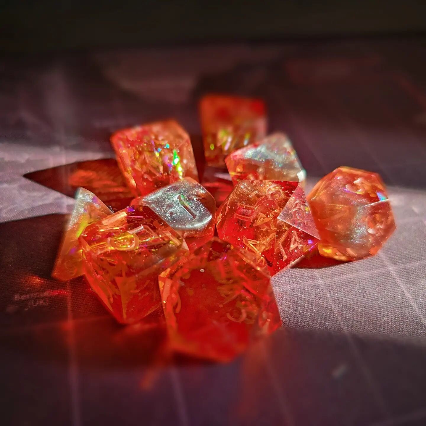 Working on a new set of dice!  This fiery set of dice has frozen molten metal inside (not real metal of course) with flames all around!! Thinking of doing a metallic red inking on these dice as well, almost making them a 'fire forge' set!!

These dic