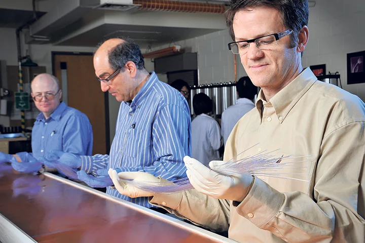 Physics professors Dr. Zisis Papandreou (right), Dr. George Lolos and Dr. Andrei Semenov work at the Detector Development Lab at the University of Regina. Department of Photography, University of Regina