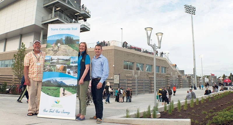 The CIBC Hamilton Pan Am Soccer Stadium where Jim Paterson (Pan Am Legacy Trails co-ordinator for Trans Canada Trail Ontario), Jane Murphy (TCT’s national director of Trail) and Michael Goodyear (Trail development manager, Eastern Canada) pose with the TCT banner. Tom Omorean
