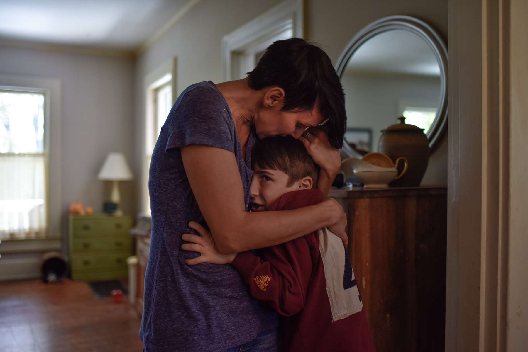 Laura Poulette embraces her son, Isaac Deaver, before leaving him at his grandmother's home for formal home-schooling.