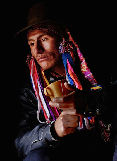 Elvis (last name withheld), a tourist guide in the Peruvian Andes, drinks coca tea after a long day of leading through the mountains. 