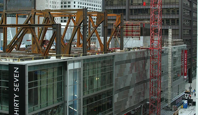 Power lift to stack 34 floors on existing urban mall