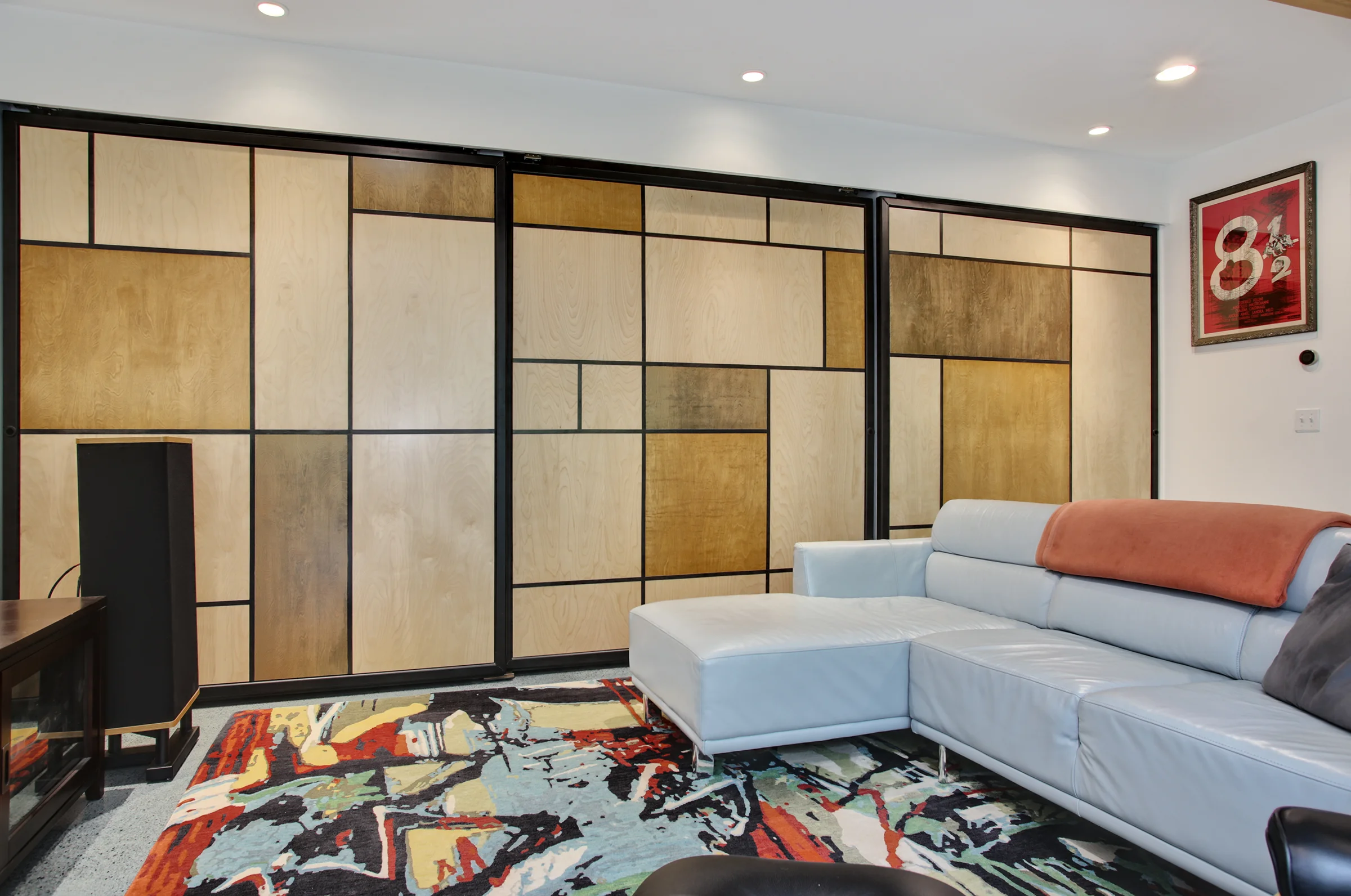  These massive steel frames, 7'x7.5', with wood inserts slide effortlessly on a roller track to reveal three separate micro rooms. 
