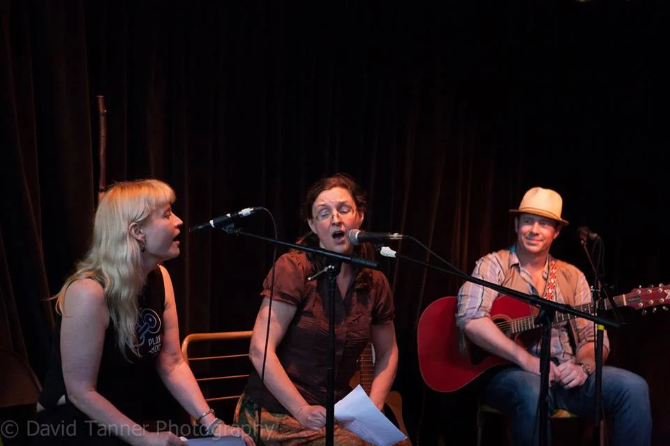Lynette and Kari Tauring singing some verses from The Kalevala, June 19, 2014, at the Hootenany, Harriet Brewing, Minneapolis, with George Scott McKelvey looking on. Photo by David Tanner.