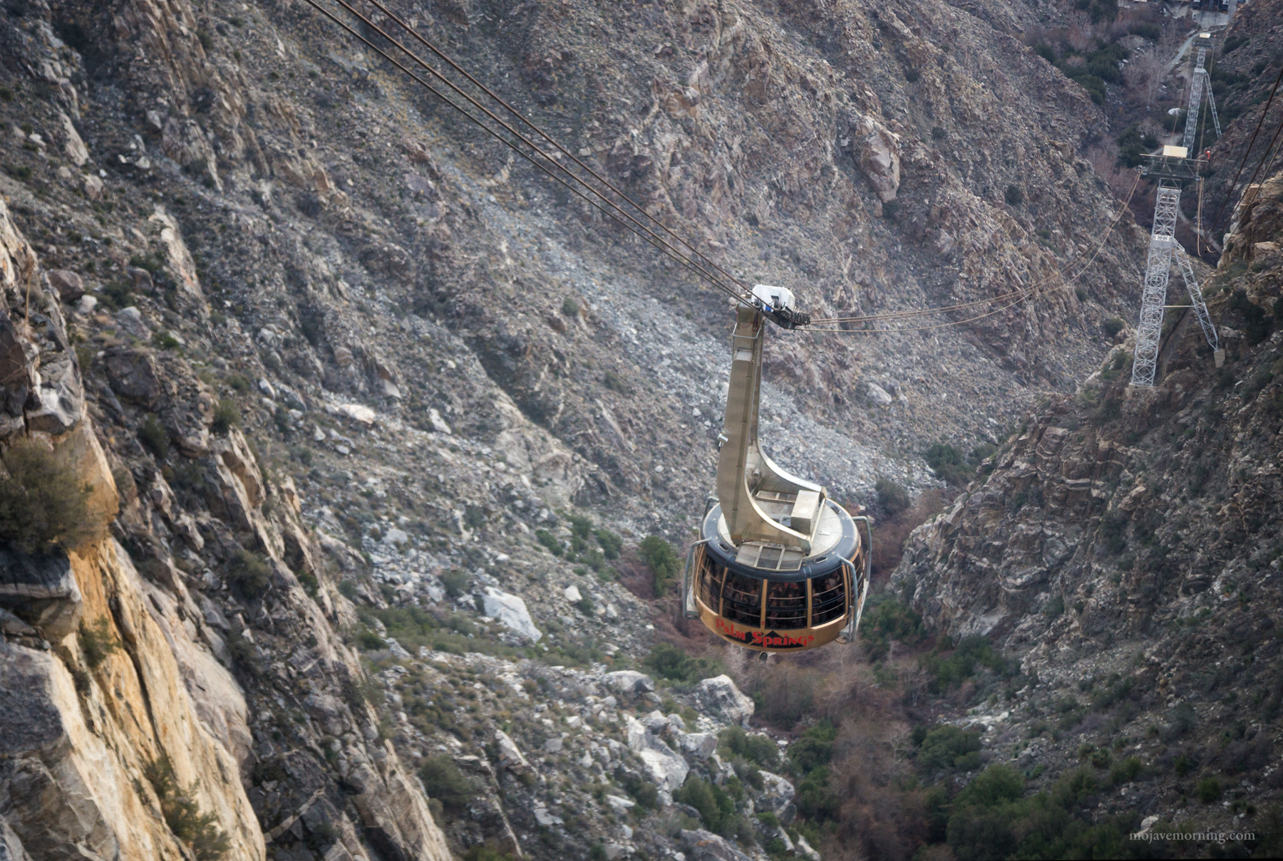 Halfway up the mountain, the tram passes the descending car. Since the cars counterbalance each other, they pass at the midpoint.