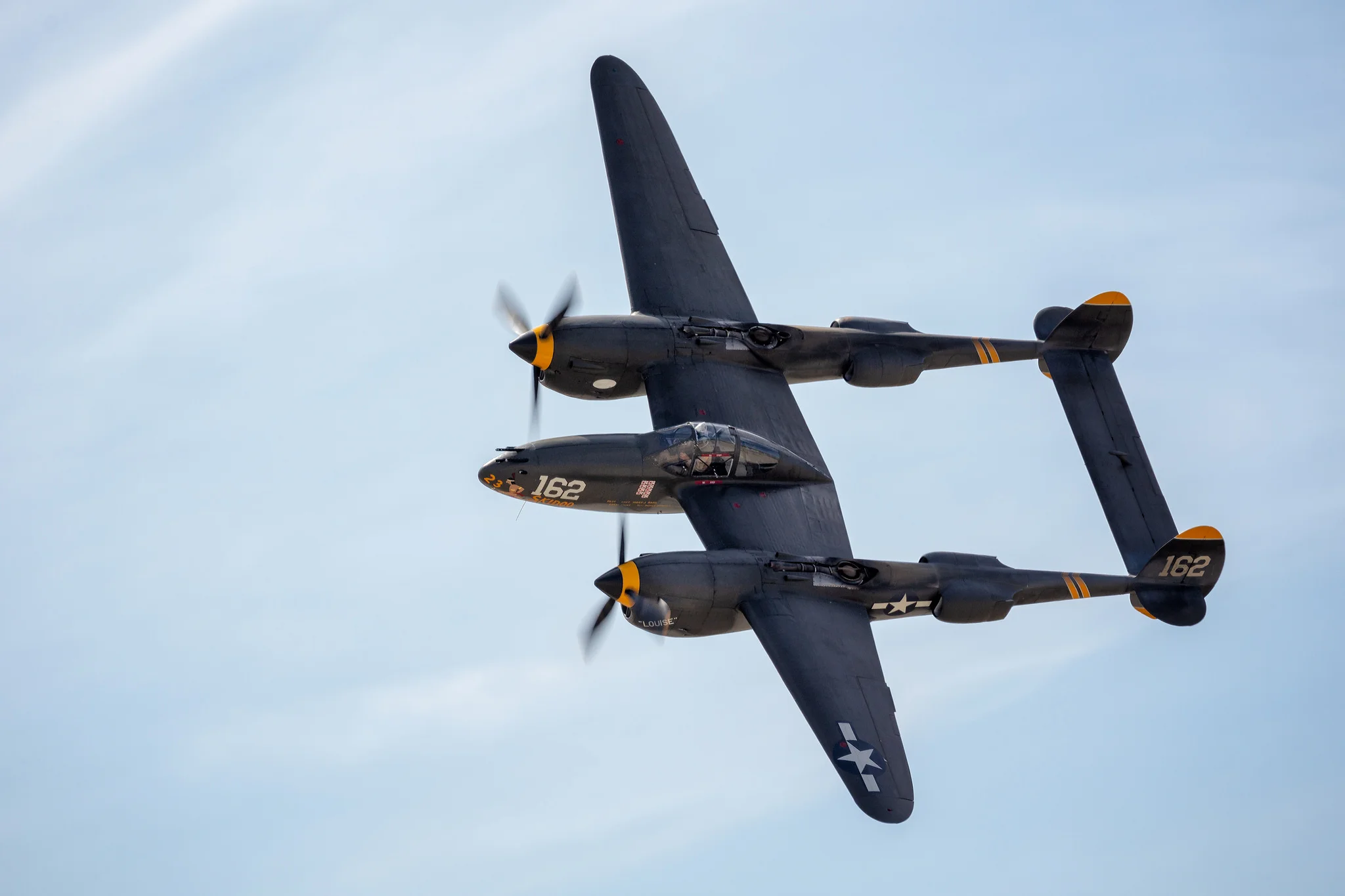 The P-38's twin 12-cynlinder Allison engines tear up the sky