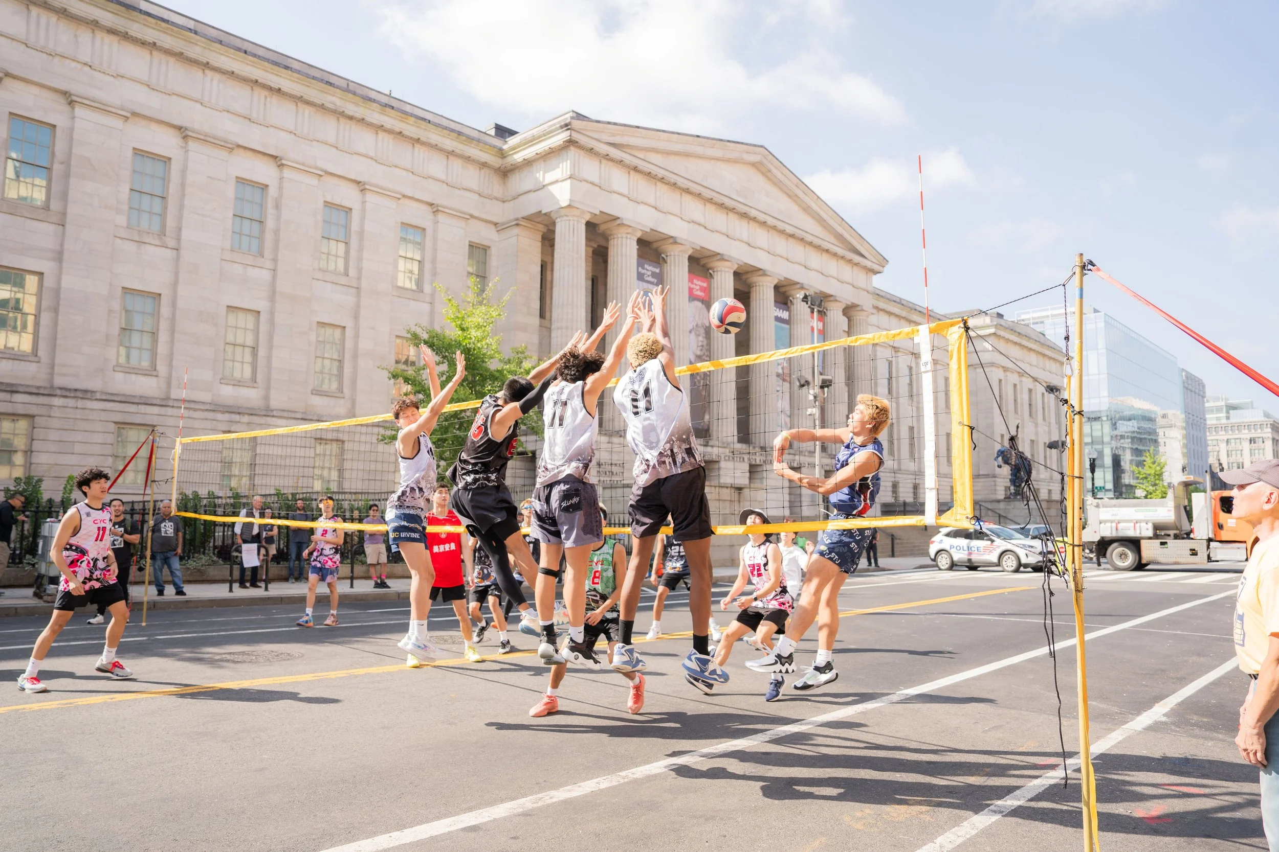 Teenaged boys playing volleyball