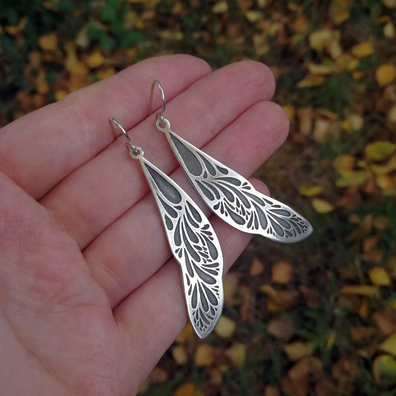 Oxidized_Wing_Earrings_hand_.jpg