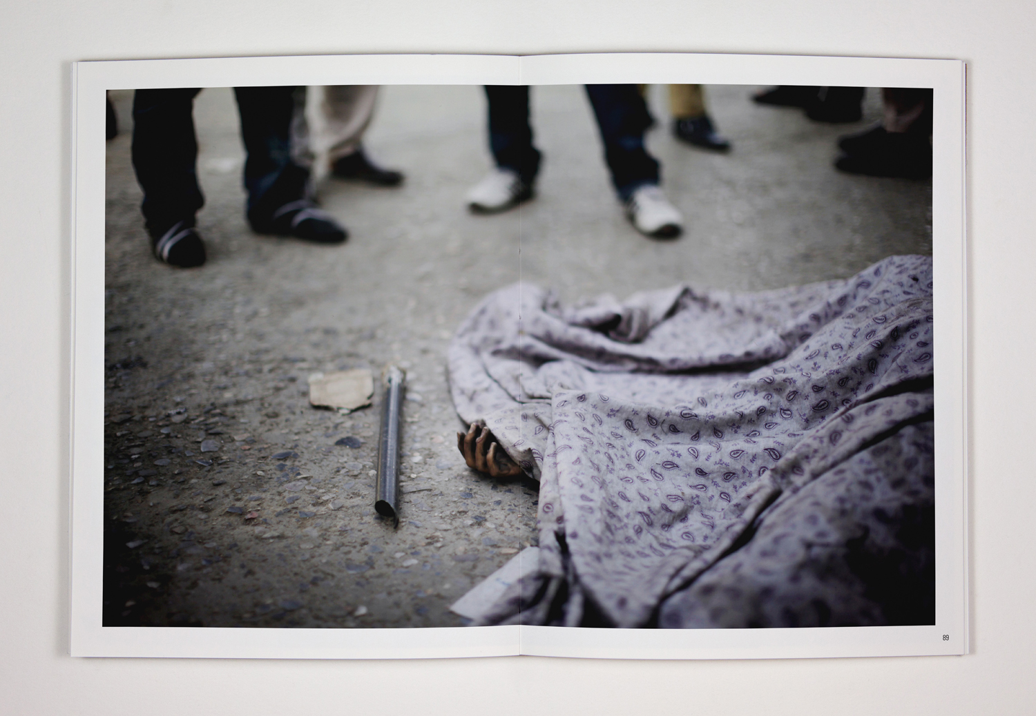 91. The corpse of a civilian who appears to have been an innocent bystander lies in the street after a gun battle in central Kabul. Three suicide bombers attacked a police station, killing nine and injuring ten others. 18th June 2011, Kabul, Afghanistan