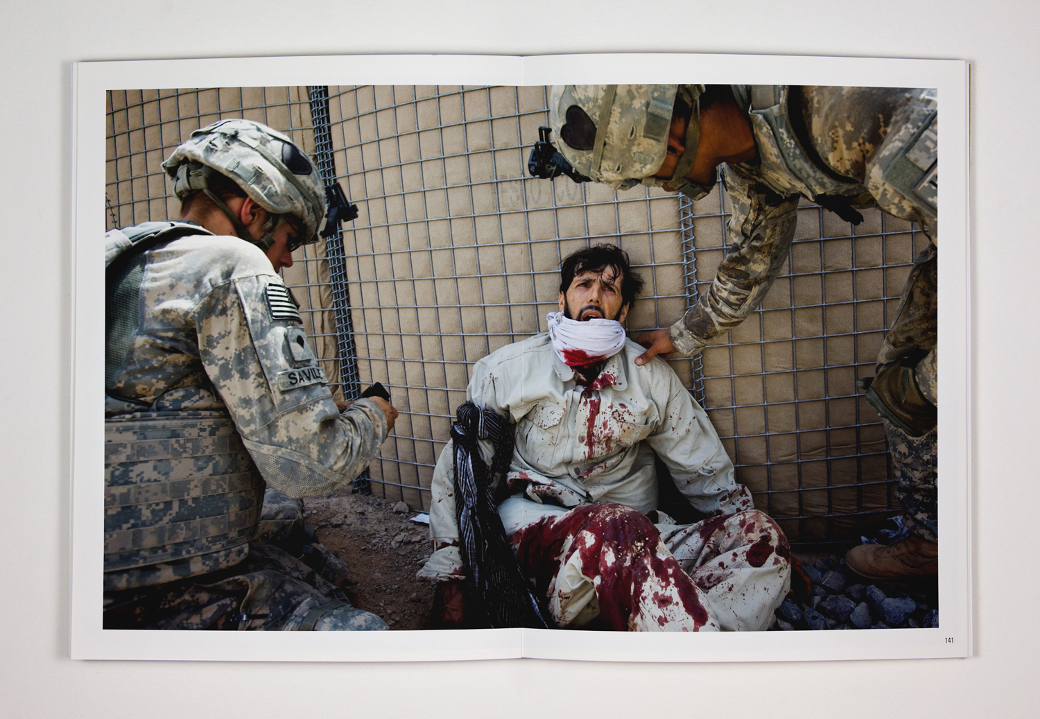 143. American medics based at Forward Operating Base Howz-e-Madada treat a severely injured Afghan employee of a private security company. The afghan militiaman was guarding a NATO supply convoy when it was ambushed by the Taliban. 17. July 2010. Zhari District, Kandahar Province, Afghanistan
