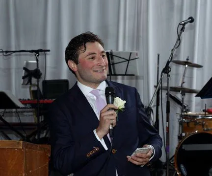 Who am I? I'm a New York based actor, voice over artist, Hebrew teacher and smiley person, but nothing makes me smile quite as big as a wedding does. No joy is quite as genuine as the kind that fills a wedding and I would love to help make that day as joyous (and smiley) as possible. I look forward to collaborating with couples to create a ceremony that is as unique and singular as the love they share. And as a lifelong New Yorker, I can't think of a better city to do it in!