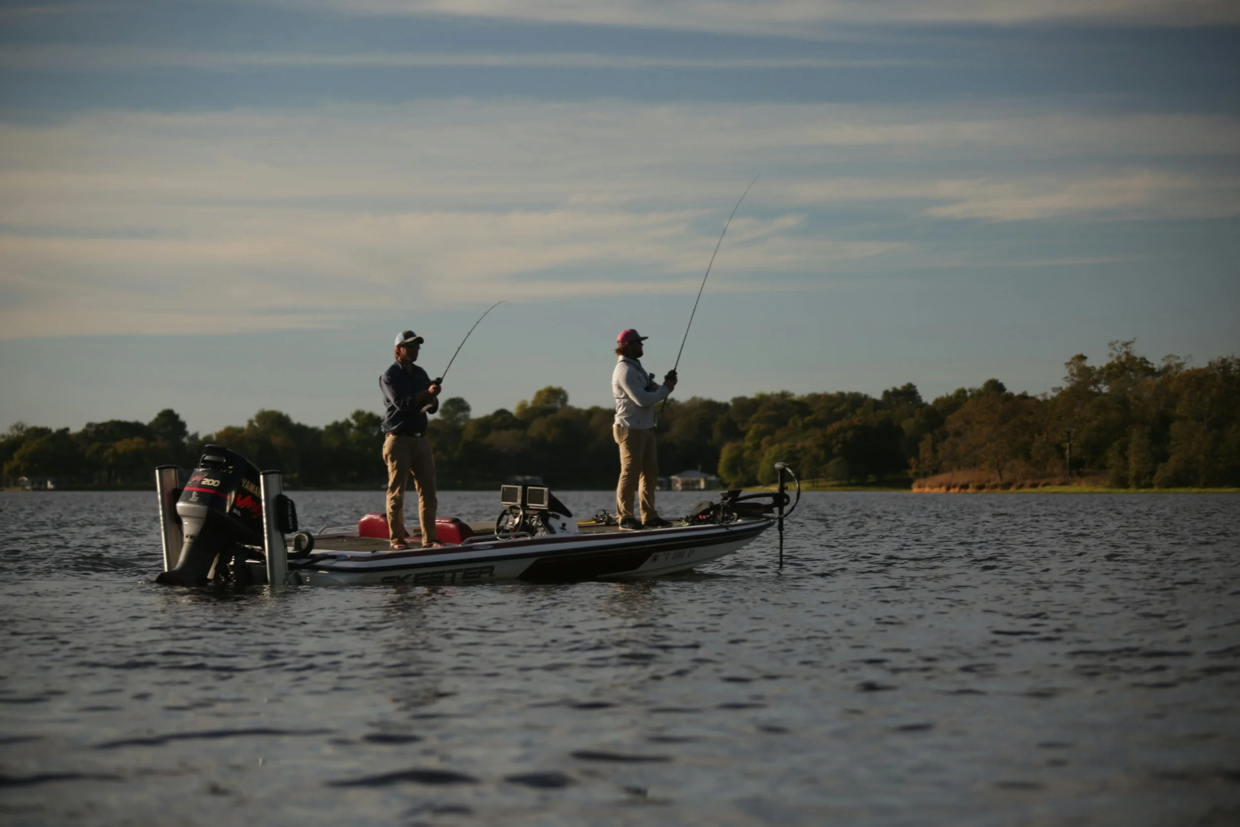 two men inshore fishing from boat
