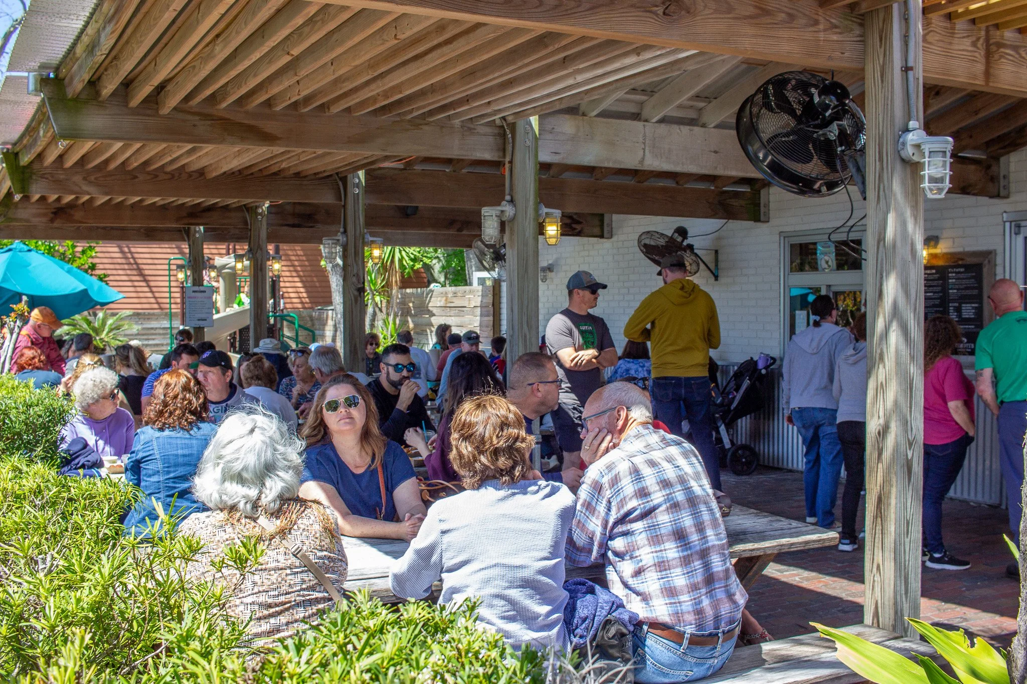 Patrons sit outside at Timoti's on a sunny day