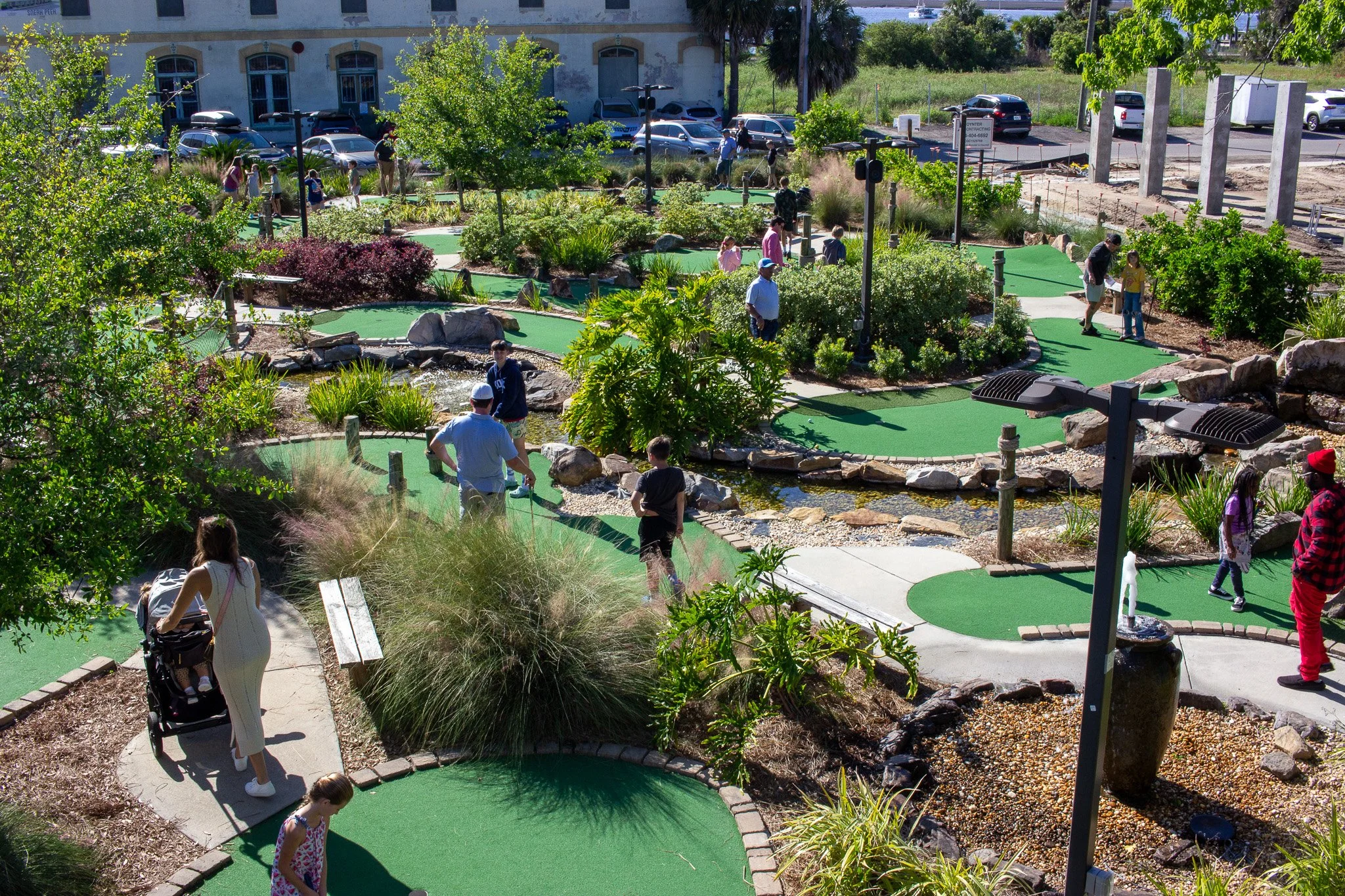 Families playing the mini golf course