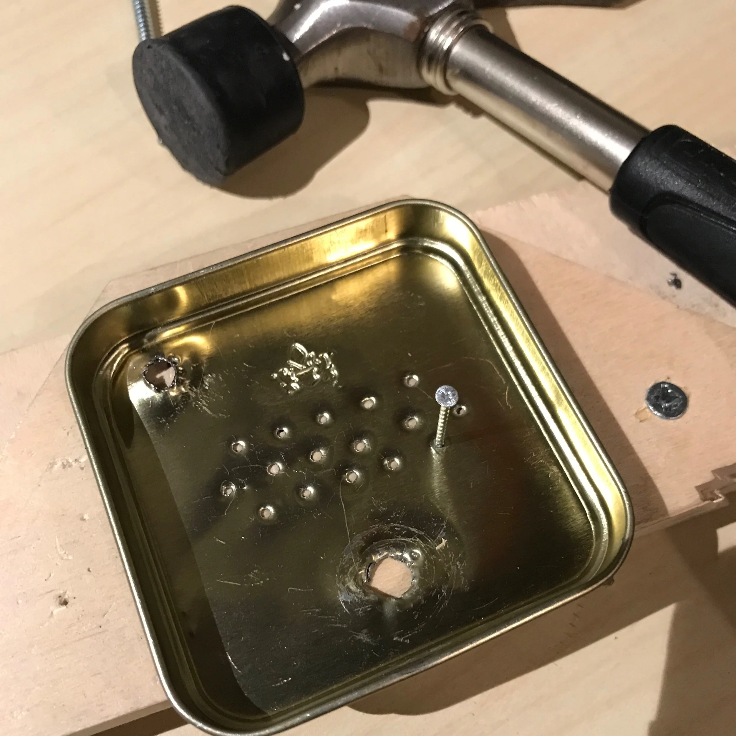 make a small holes for the speaker with the nail and hammer