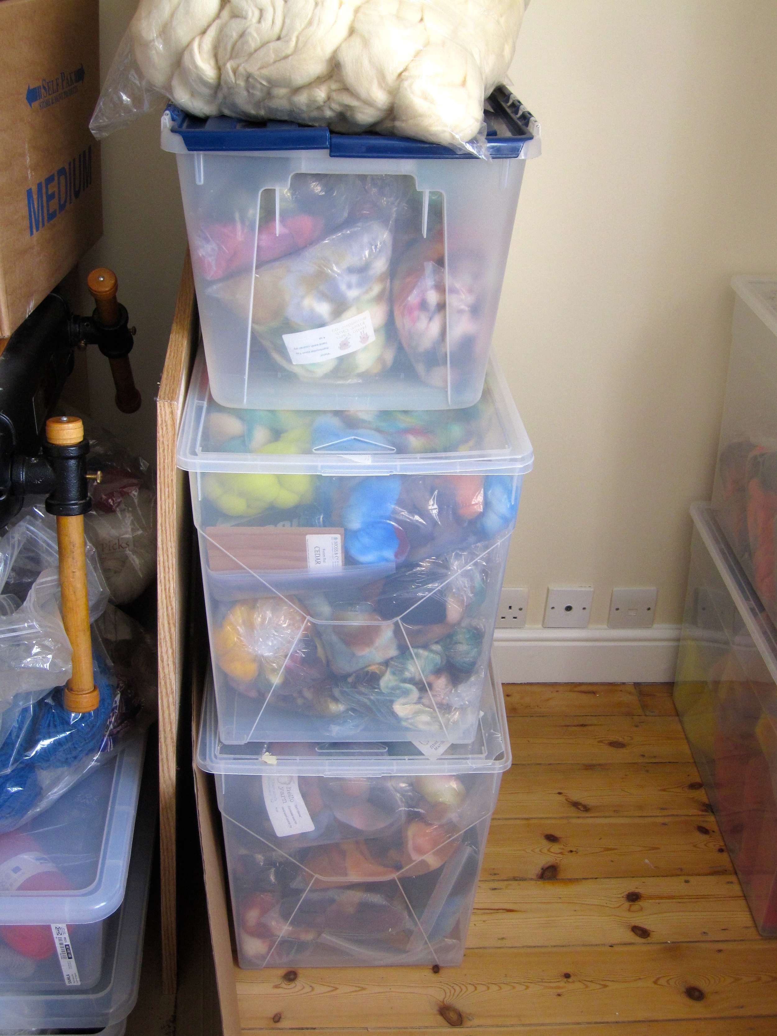 Personal fiber stash plus bins of yarn for designs.