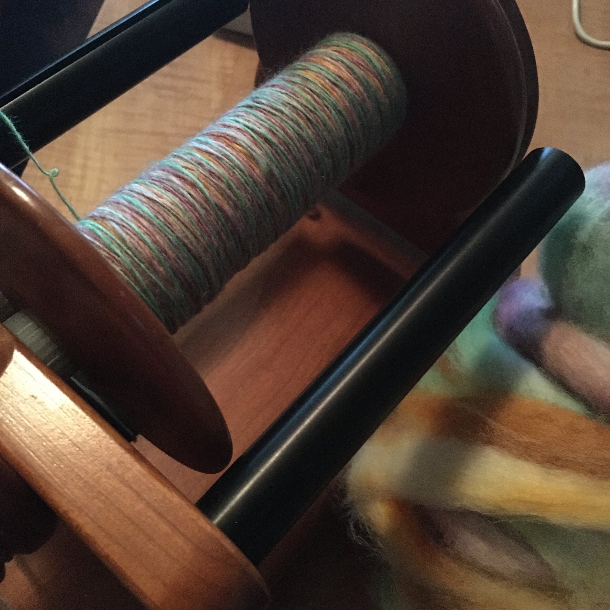 Photo of multicolored singles in progress, with fiber in background