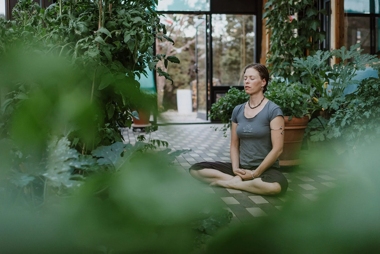 Chanda meditates amongst garden plants