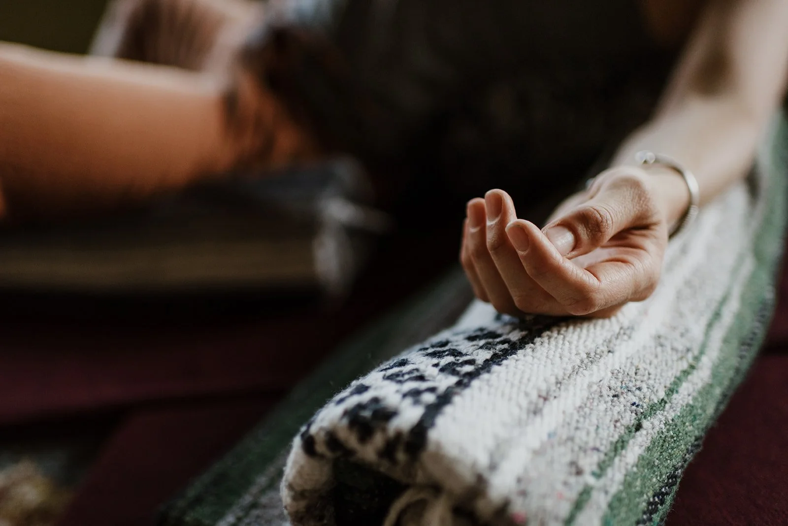 Chanda's hand and arm rest in a supported posture